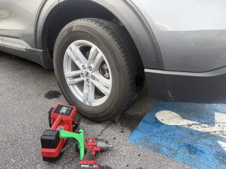 Impact tools staged beside a wheel