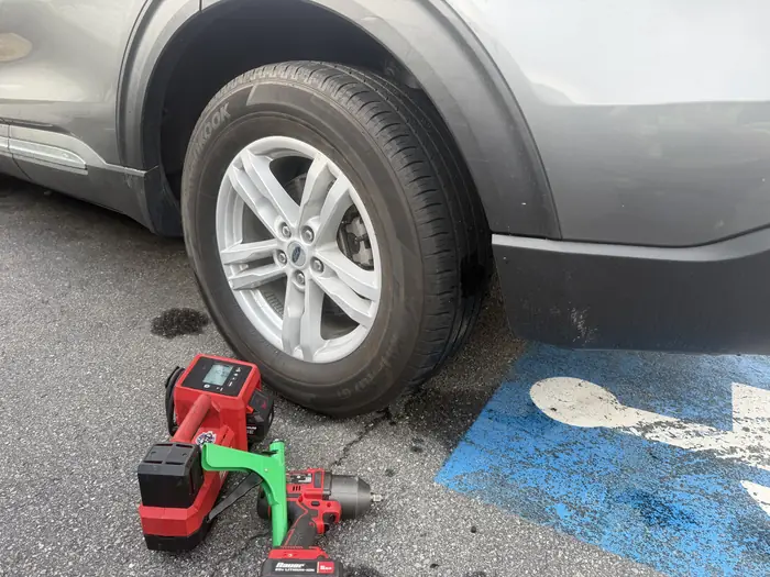 Impact tools staged beside a wheel